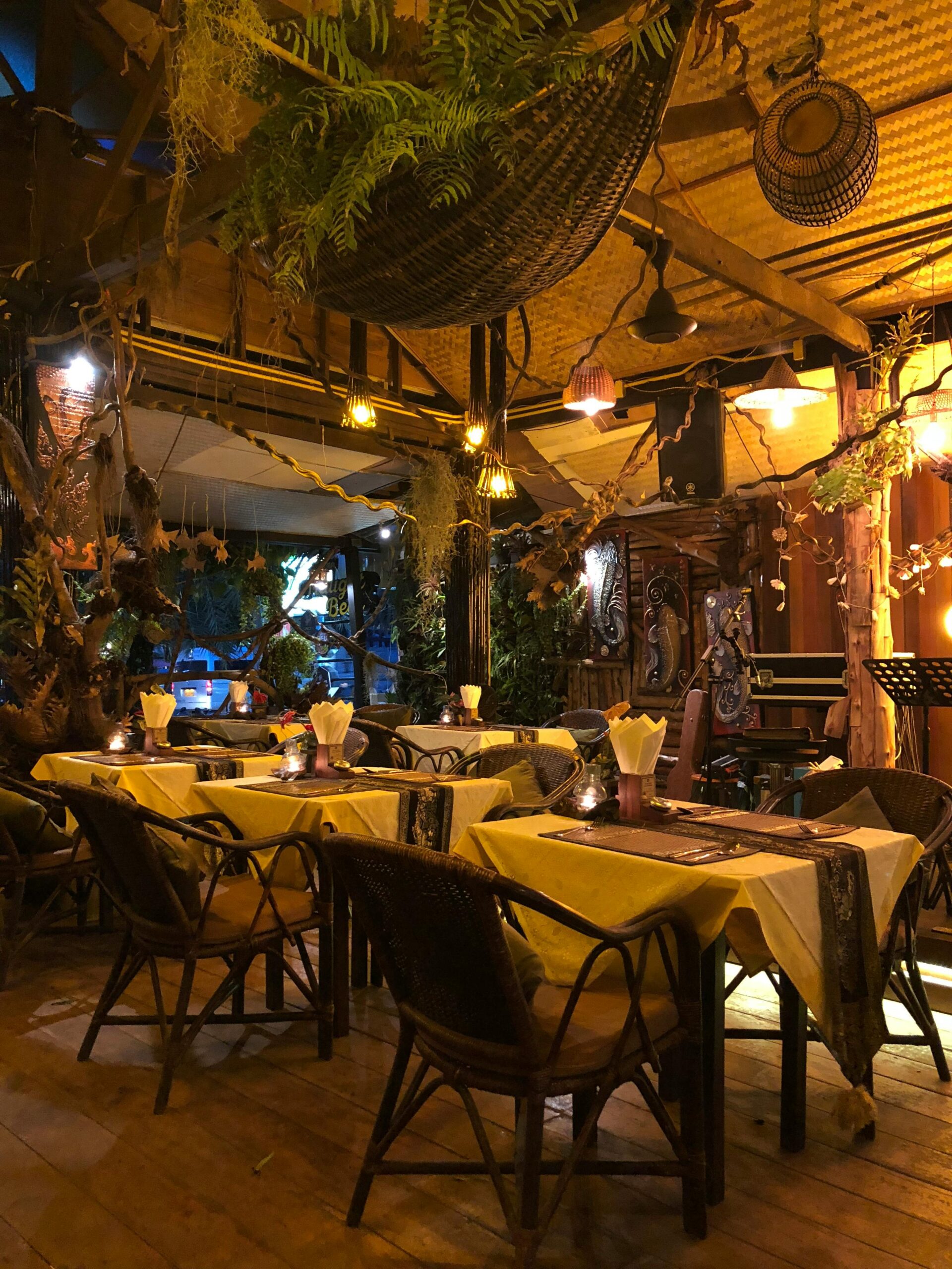 Charming rustic restaurant setting with warm lighting and decorative plants, perfect for a cozy dining experience.