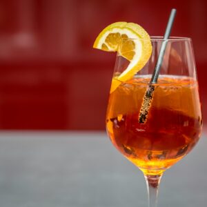 Bright Aperol spritz with lemon slice on a glass, perfect for summer refreshment.