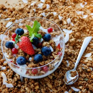 A top view of a healthy granola breakfast with fresh berries and yogurt in București.