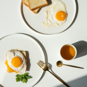 Minimalist breakfast featuring fried eggs, toast, and balanced composition for a fresh start.