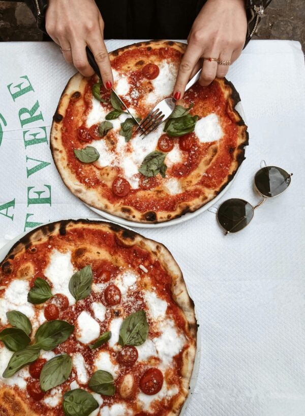 Enjoy a classic Margherita pizza in a Roman restaurant, perfect for a relaxed Italian meal.