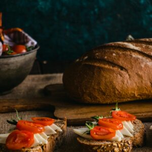 Delicious rustic bread topped with cheese and tomatoes served in a cozy indoor setting in Istanbul.