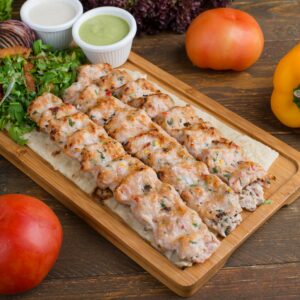 Sizzling grilled chicken kebabs served with fresh vegetables and sauces.