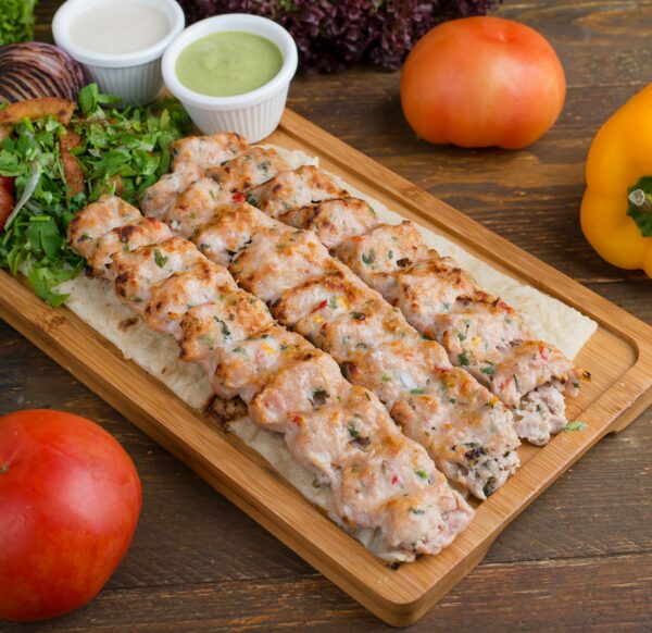 Sizzling grilled chicken kebabs served with fresh vegetables and sauces.