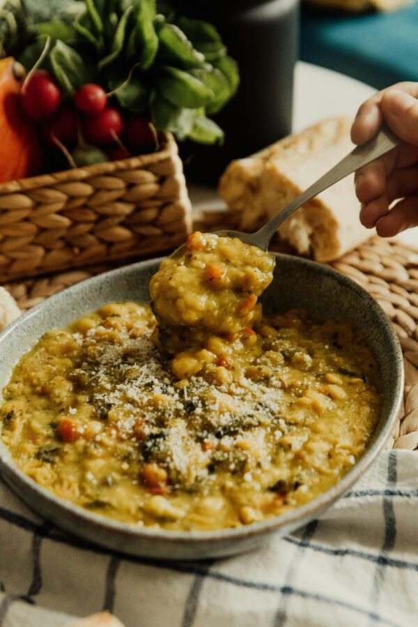 Close-up of lentil soup in a ceramic bowl with fresh vegetables, Erfurt.