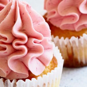 Delicious close-up image of pink-frosted cupcakes, perfect for dessert enthusiasts.